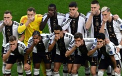 Germany's players cover their mouths as they pose for a picture before their World Cup opener