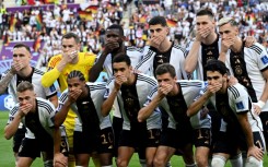 Germany's starting XI including Chelsea forward Kai Havertz (third from right, top) cover their mouths in protest against FIFA before Tuesday's match against Japan