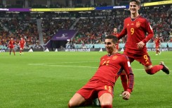 Spain forward Ferran Torres celebrates with teammates after scoring his team's fourth goal against Costa Rica