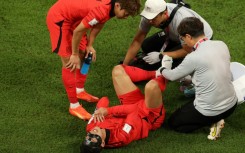 South Korea's Son Heung-min receives medical treatment after being on the end of a nasty Uruguay challenge