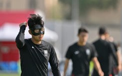 The masked Son Heung-min takes part in a World Cup training session