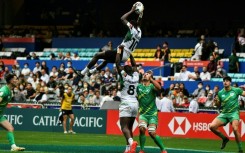 Kenya's Johnstone Olindi (top) is lifted by teammate Herman Humwa (C) against Ireland in the Hong Kong Sevens rugby tournament on November 4, 2022.