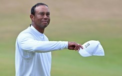 US golfer Tiger Woods gestures to the fans during the 150th Open Championship at St. Andrews