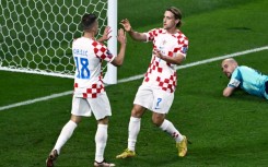 Croatia midfielder Lovro Majer (right) celebrates scoring his team's fourth goal against Canada