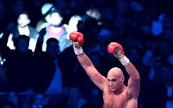 Triumphant champion - Britain's Tyson Fury celebrates retaining his WBC heavyweight title after a 10th-round stoppage of Derek Chisora