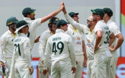 Australia's Nathan Lyon (3rd R) celebrates after taking the wicket of West Indies' Kraigg Brathwaite 