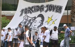 Fans taking part in a vigil for ailing Brazilian superstar Pele hold up a banner reading "Torcida Joven" ("Young Fans" on December 4, 2022 in Sao Paulo