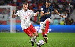 France forward Kylian Mbappe races away from Poland's Kami Glik during Les Bleus' last 16 victory