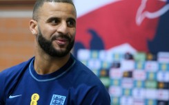 England defender Kyle Walker plays darts against a journalist at the team's World Cup training camp