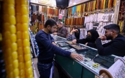 Iranian visitors shop for rings at a jewellery store in the Iraqi city of Najaf