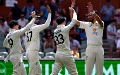 Australia's Mitchell Starc (R) celebrates after running out Tagenarine Chanderpaul of the West Indies