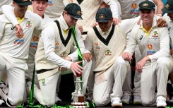 The Australian team pose with the series trophy after winning the second Test between Australia and the West Indies 