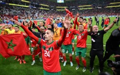 Morocco players celebrate with their supporters after they beat Portugal in the World Cup quarter-finals