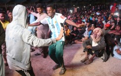 Pakistani football fans dance as they watch the live broadcast of the World Cup semi-final between Argentina and Croatia in the Lyari neighbourhood of Karachi