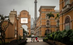 Visitors walk on the Cotai Strip, Macau's main gambling area, on Friday