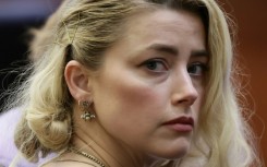 Actress Amber Heard says she has reached a settlement in the defamation case brought against her by her ex-husband Johnny Depp