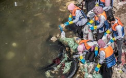 Volunteers collect garbage from the Nile in Egypt's capital Cairo in a clean-up campaign, on March 7, 2020