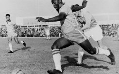 In this photo taken on May 8, 1960, Brazilian football legend Pele dribbles past a defender during a friendly match between Malmo and Brazil, in Sweden