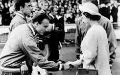George Cohen, with teammate goalkeeper Gordon Banks hehind,  him, bows as he shakes hand with Queen Elizabeth II at Wembley stadium in London before the start of the World Cup