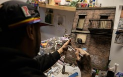 The 42-year-old Danny Cortes adds meticulous detail to one of his miniature New York street scenes