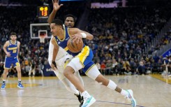 Golden State's Jordan Poole drives to the basket past Utah's Malik Beasley in the Warriors' 112-107 NBA victory over the Jazz