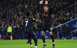 Arsenal's William Saliba (R) and Bukayo Saka celebrate against Brighton 