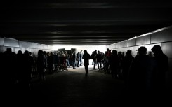 People shelter in an underground pedestrian crossing during missile strikes in Kyiv on New Year's Eve