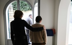 A caretaker helps an elderly resident suffering from Alzheimer's in a home on the outskirts of Paris