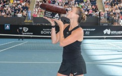 Aryna Sabalenka holds the trophy after winning the Adelaide International 