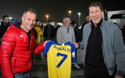 Name game: Former world rally champion Sebastien Loeb (left) is presented with a Cristiano Ronaldo Al-Nassr shirt by the club's French coach Rudi Garcia at the Dakar Rally in Riyadh on Sunday