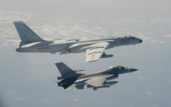A Taiwanese F-16 fighter jet flying next to a Chinese H-6 bomber (top) in Taiwan's airspace