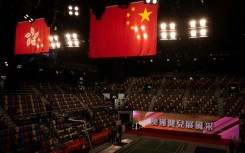 Flags of China (R) and Hong Kong hang above Hong Kong’s Queen Elizabeth Stadium