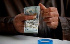 Some Iraqi officials have placed the blame for the dinar's woes squarely on the shoulders of one actor -- the United States