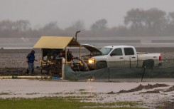 A person watches dangerously large surf hitting California's Monterey Peninsula on January 13, 2023 as the US state braced for the latest in a weeks-long series of powerful storms 