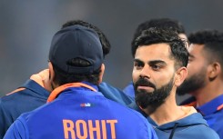 India's Virat Kohli (R) speaks with Rohit Sharma