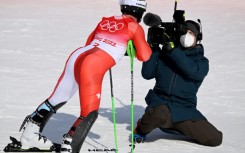 Swiss skier Justin Murisier posing for a television closeup after the men's alpine combined slalom event during the Beijing 2022 Winter Olympics