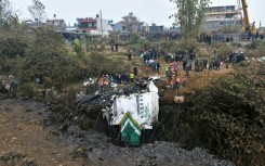 Rescuers search the wreckage of a Yeti Airlines plane crash but there was little hope of finding any survivors among the 72 people on board