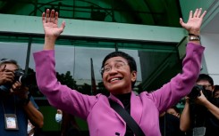 Nobel Prize winner Maria Ressa waves to supporters Wednesday after her acquittal on all four charges of tax evasion filed against her