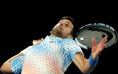 Novak Djokovic serves against France's Enzo Couacaud 