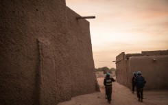 Police officers from the UN peacekeeping mission in Mali guard the entrance to the Great Mosque of Timbuktu