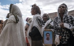 People mourn the victims of a massacre allegedly perpetrated by Eritrean soldiers in the village of Dengolat, north of Mekele, the capital of Tigray on February 26, 2021