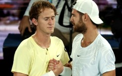 Russia's Karen Khachanov (R) embraces American Sebastian Korda