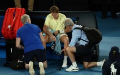 Sebastian Korda talks with a physio in the Australian Open quarter-final