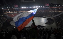 A spectator waves the Russian flag ahead of the opening ceremony of the 2018 Pyeongchang Winter Olympics