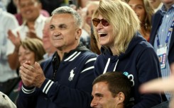 Novak Djokovic's father Srdjan Djokovic (L) and mother Dijana Djokovic (R), react after he beats Russia's Andrey Rublev in the men's singles quarter-final match