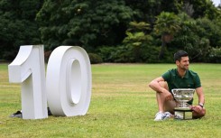 Novak Djokovic celebrates with the Norman Brookes Challenge Cup a day after his victory against Greece's Stefanos Tsitsipas