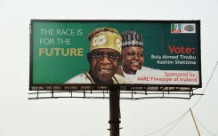 Ruling APC party candidate Bola Tinubu, seen here on a campaign poster, says the fuel and cash crisis is a bid to undermine him