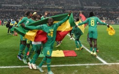 Final flourish: Senegal defender Mamadou Sane celebrates with the national flag after Saturday's final