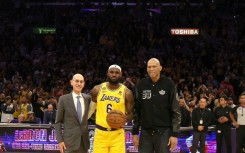 NBA Commissioner Adam Silver, LeBron James and Kareem Abdul-Jabbar stand on court after James became the NBA's all-time leading scorer on Tuesday