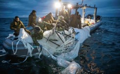 US Navy sailors recovering remants of a suspected Chinese spy balloon off the coast of South Carolina, on February 5, 2023